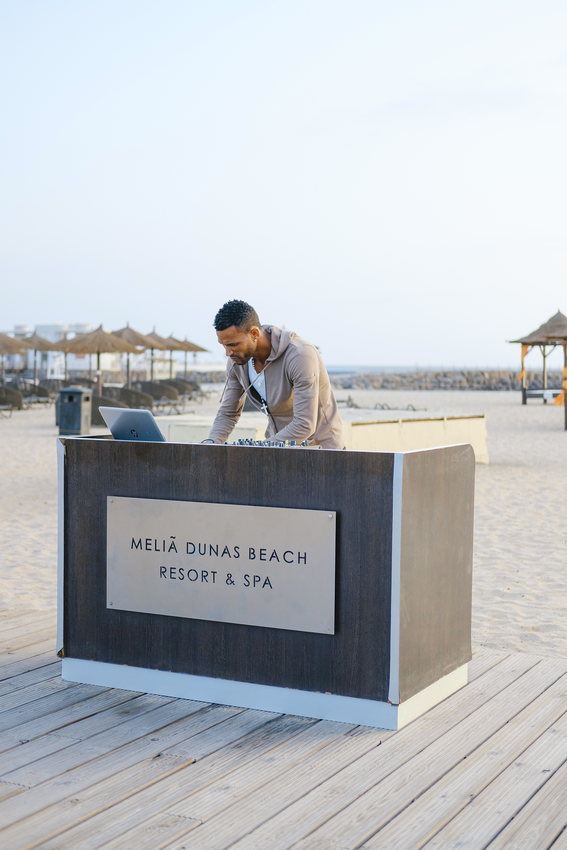 a man standing at a desk on a beach