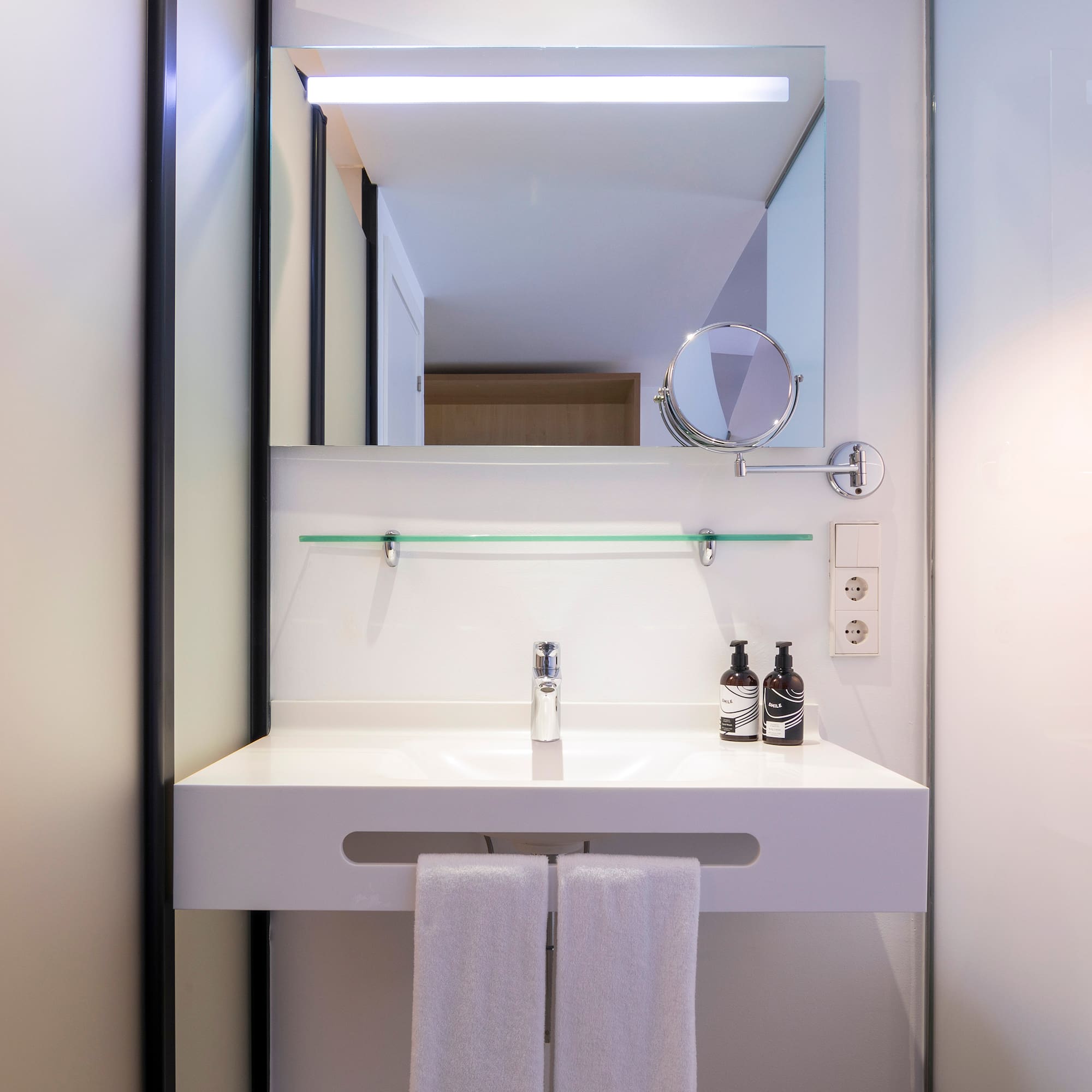a bathroom with a mirror and a sink