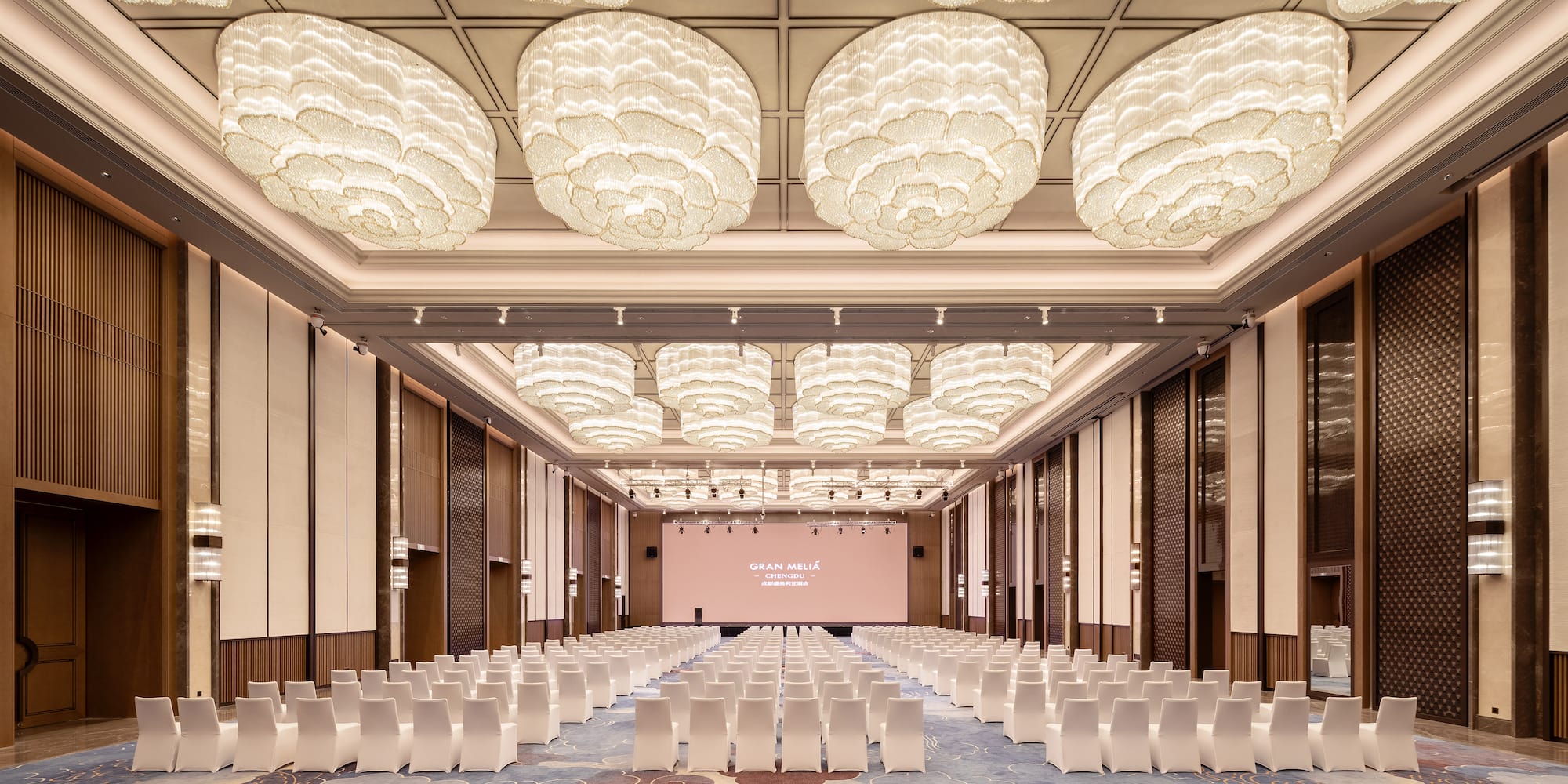 a room with chairs and a screen