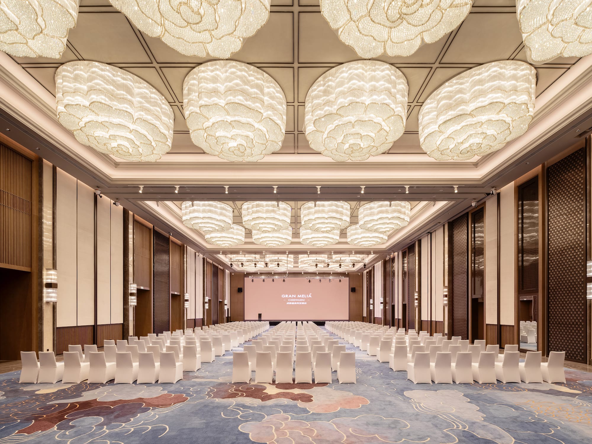 a room with chairs and a screen