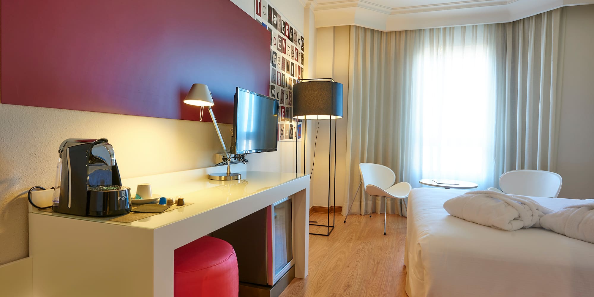 a room with a bed and a desk and a chair