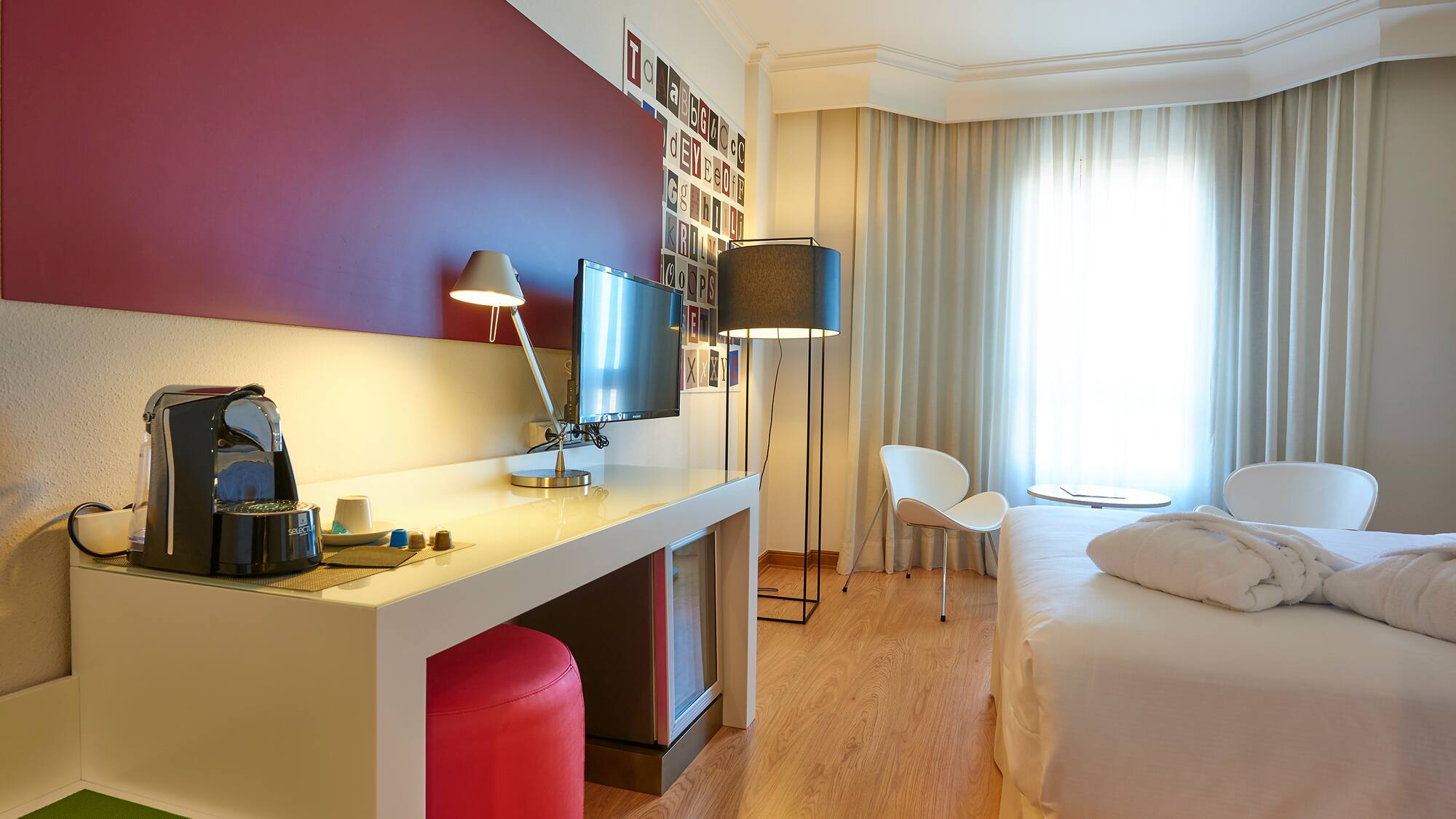 a room with a bed and a desk and a chair