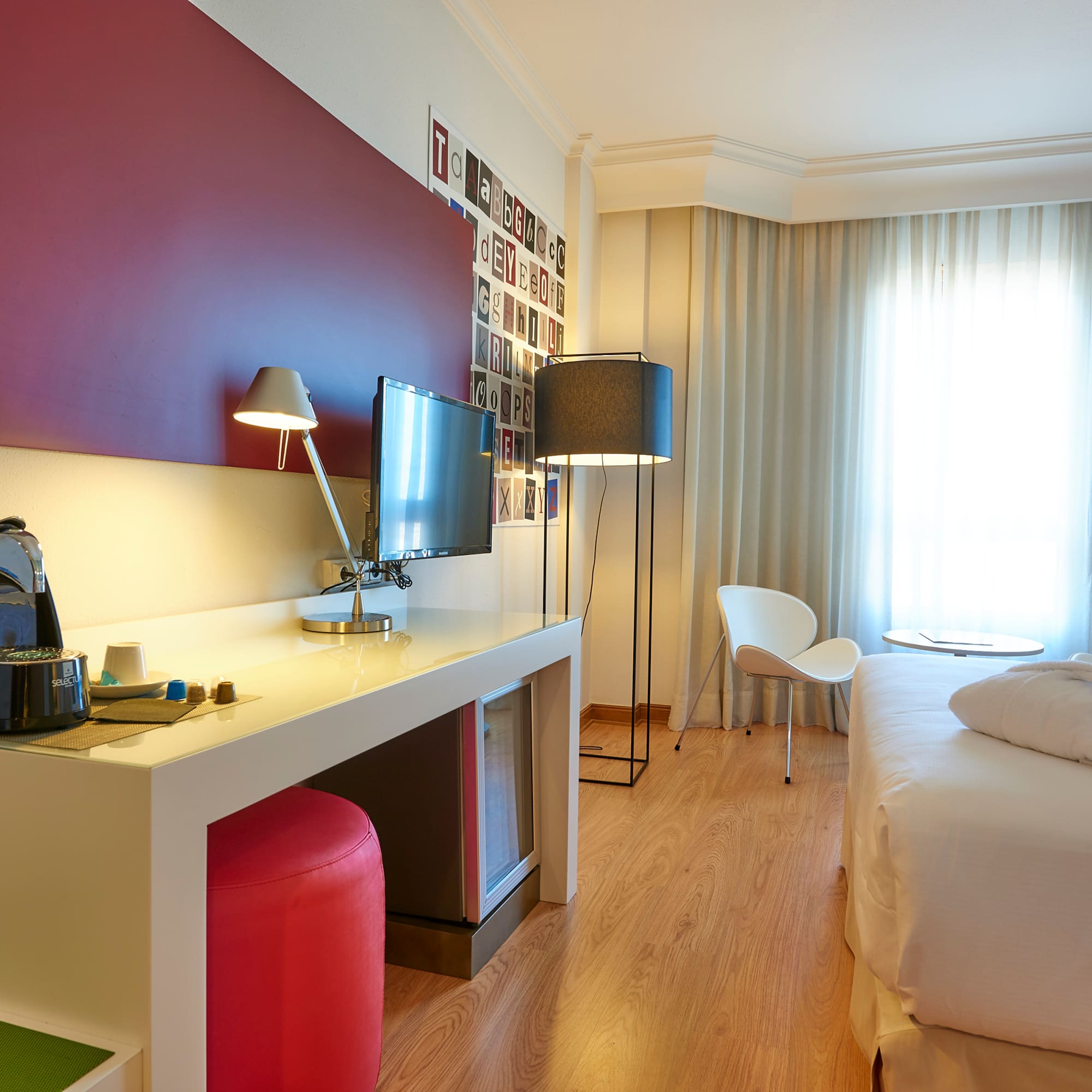 a room with a bed and a desk and a chair