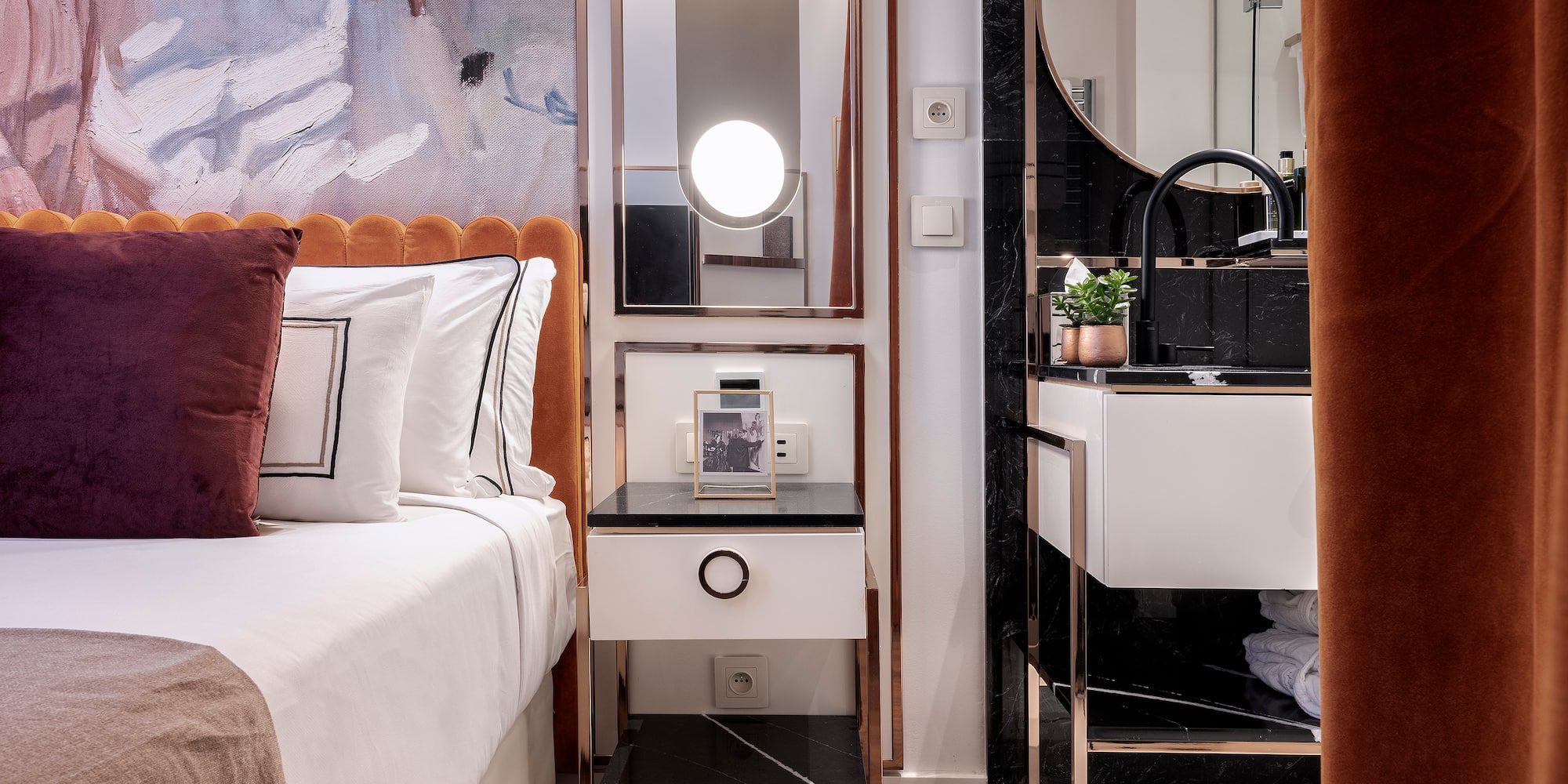 a bedroom with a mirror and a bed