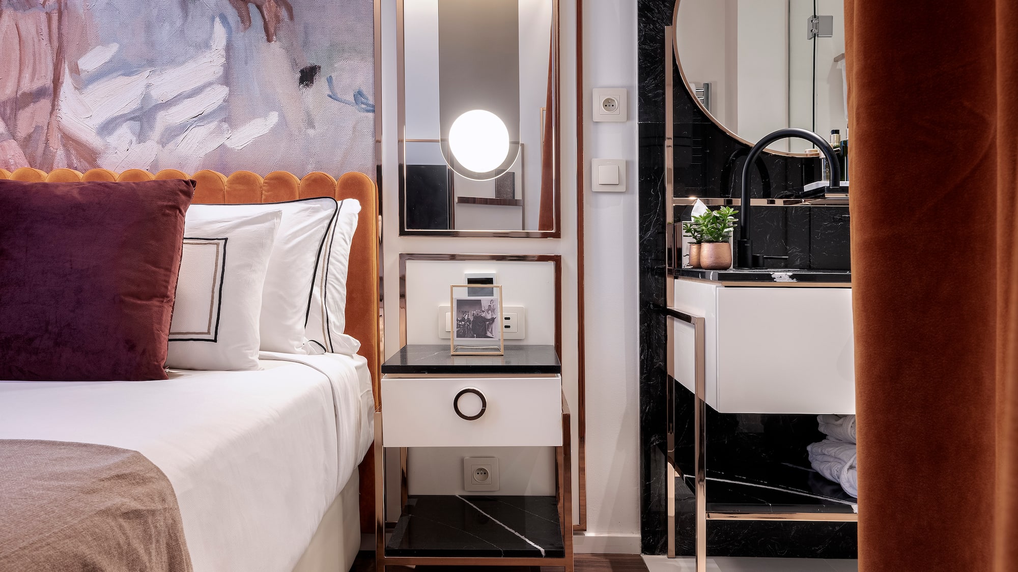 a bedroom with a mirror and a bed