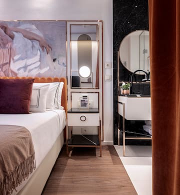 a bedroom with a mirror and a bed