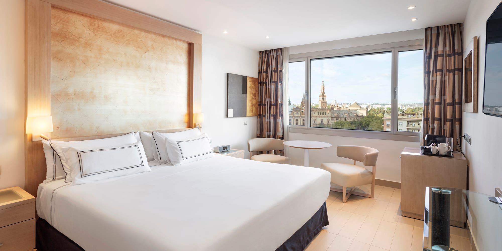 a room with a bed and a table and chairs