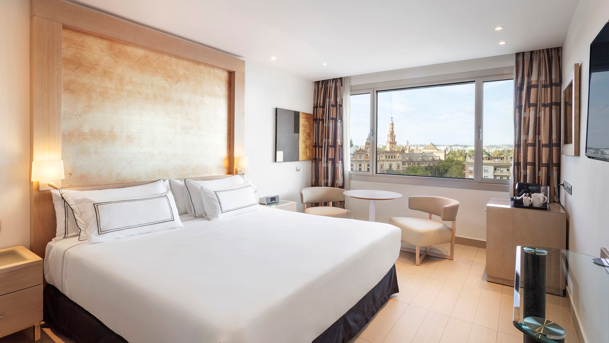 a room with a bed and a table and chairs