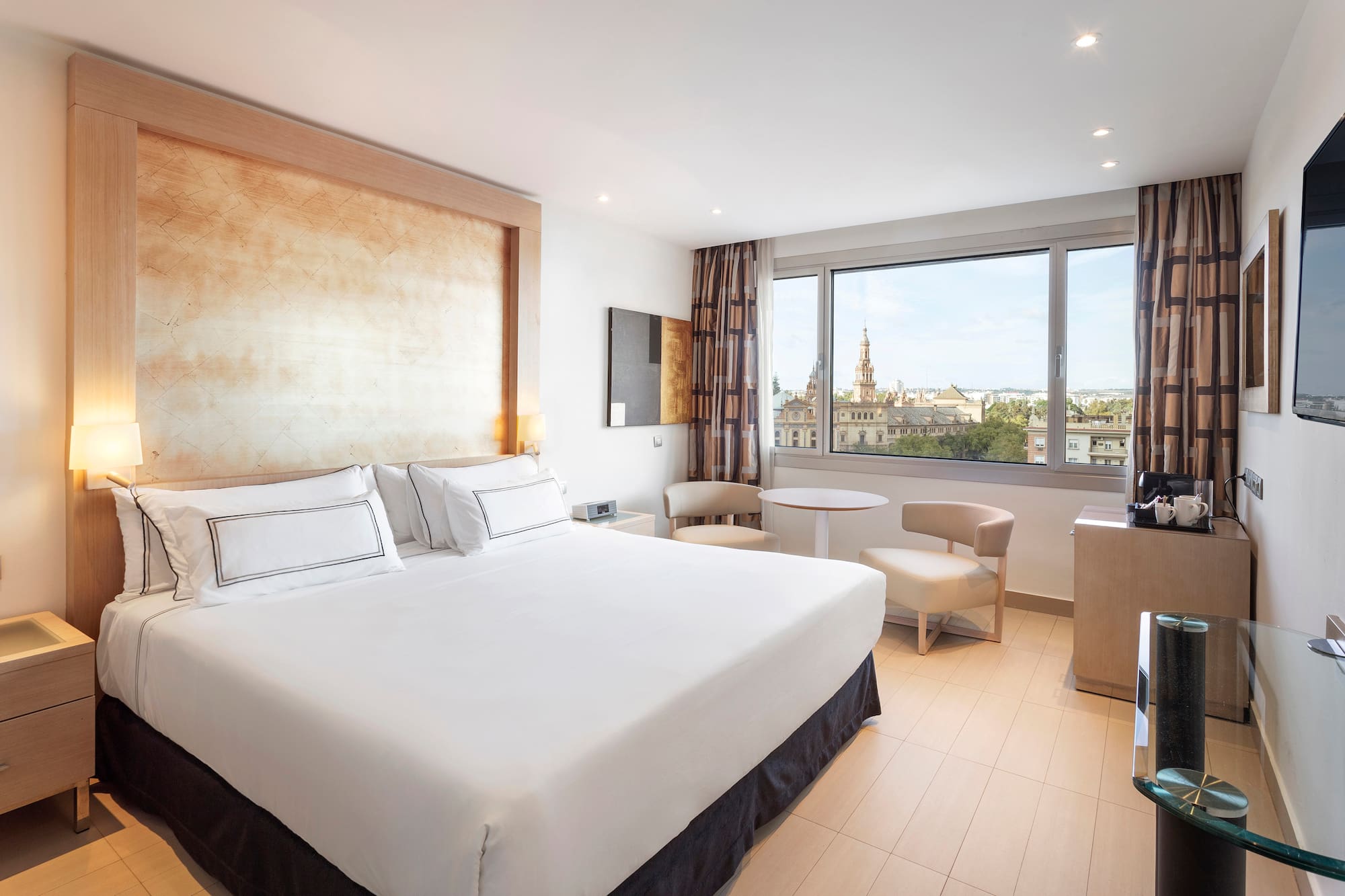 a room with a bed and a table and chairs