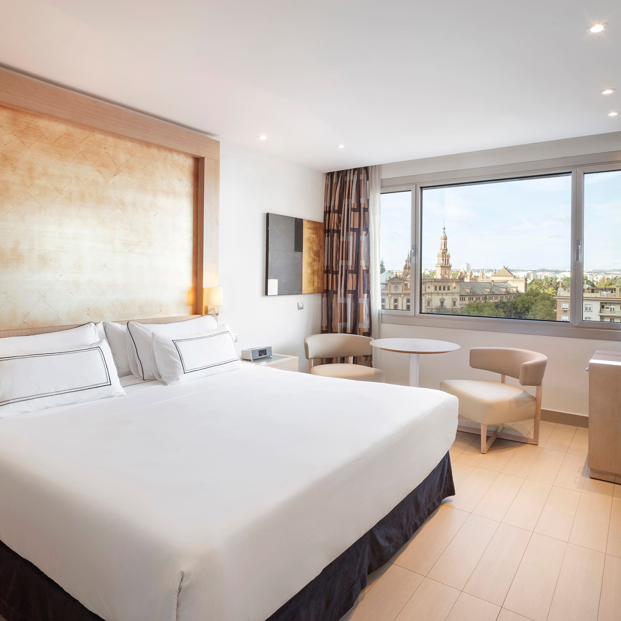 a room with a bed and a table and chairs