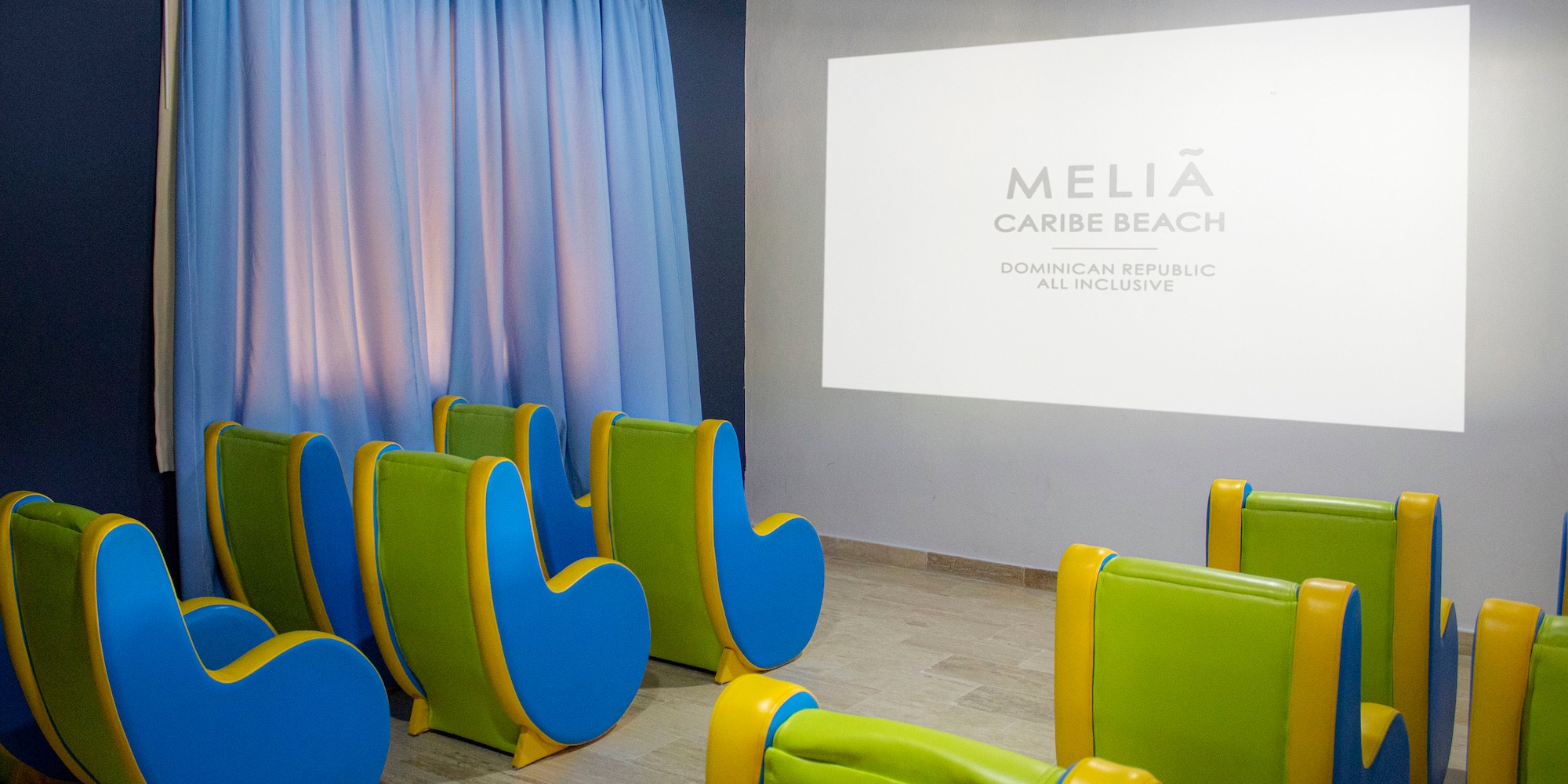 a room with chairs and a projector screen