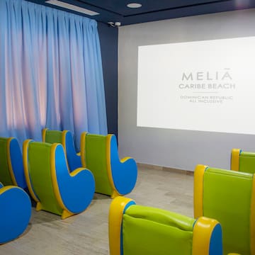 a room with chairs and a projector screen