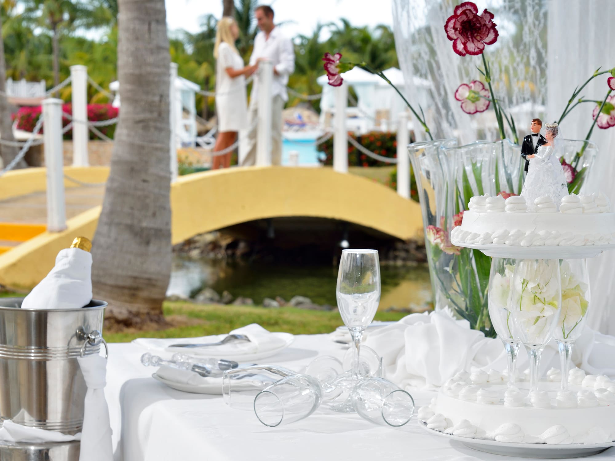 a table with a cake and glasses on it