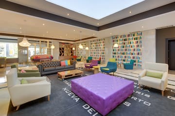 a room with colorful furniture and books on the wall