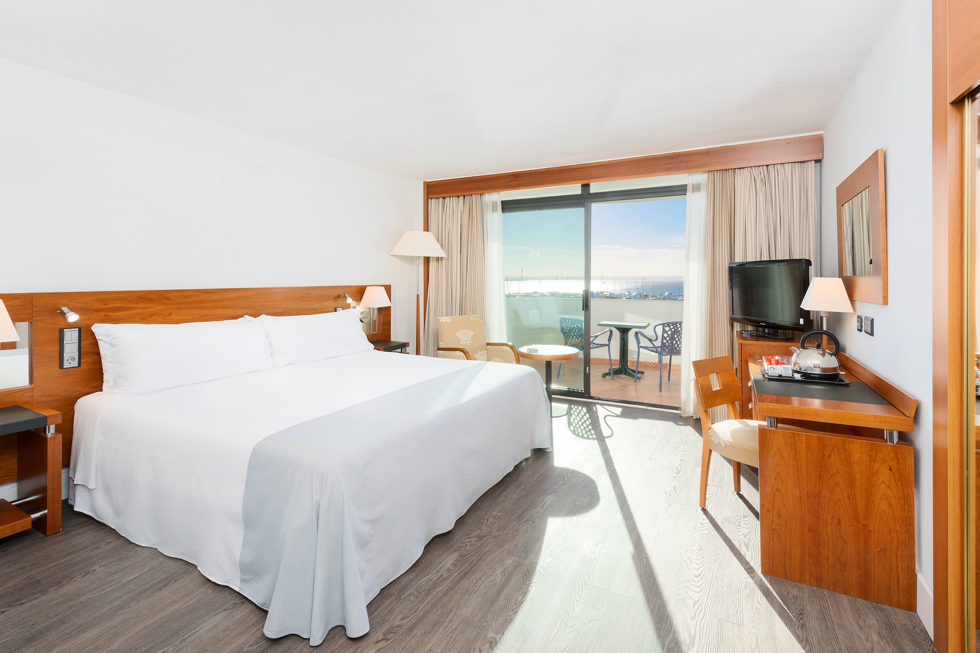 a room with a bed and a table and chairs