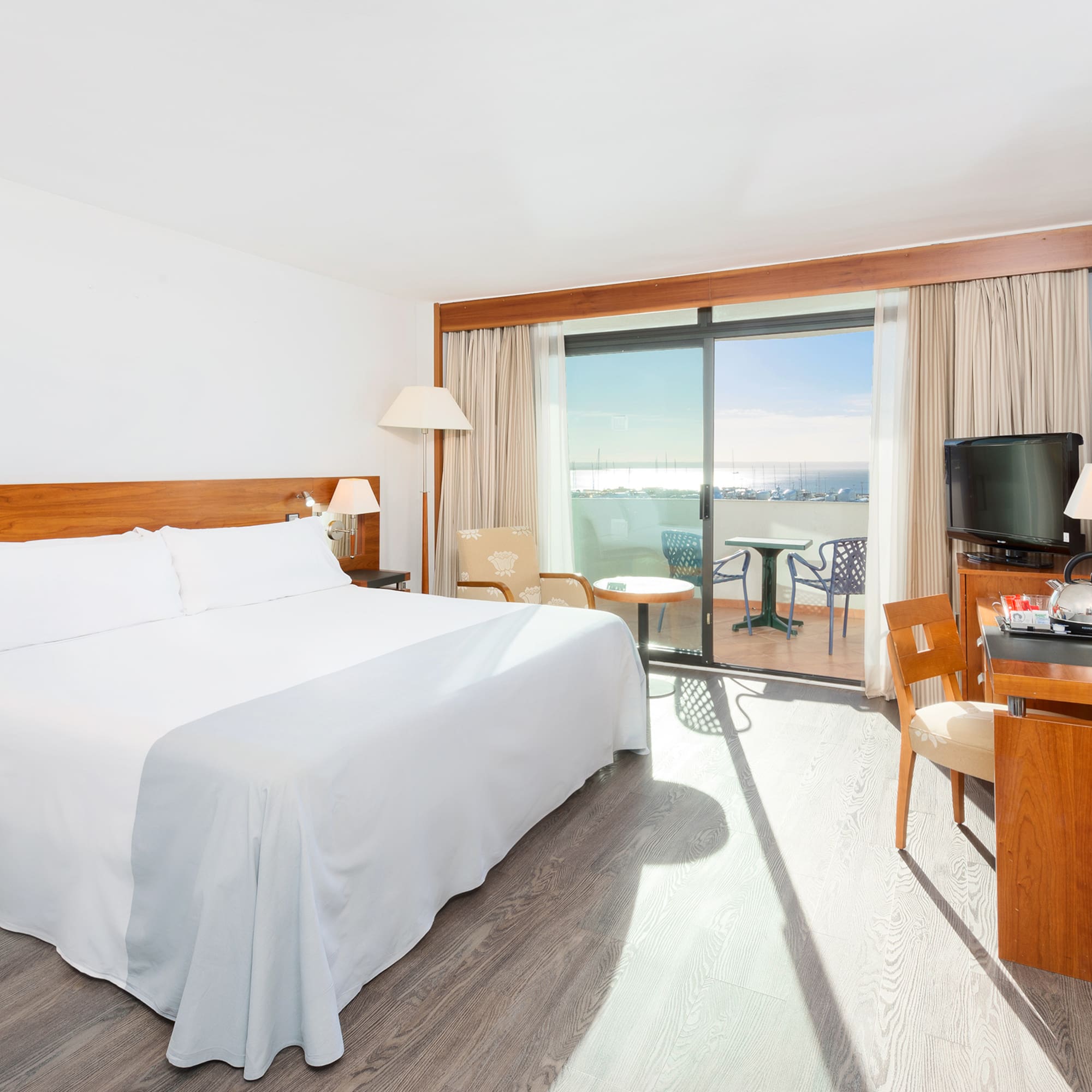 a room with a bed and a table and chairs