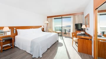 a room with a bed and a table and chairs