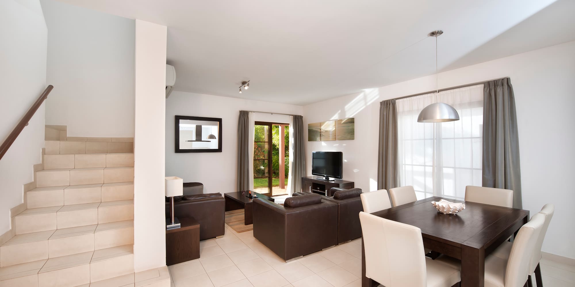 a living room with a table and chairs
