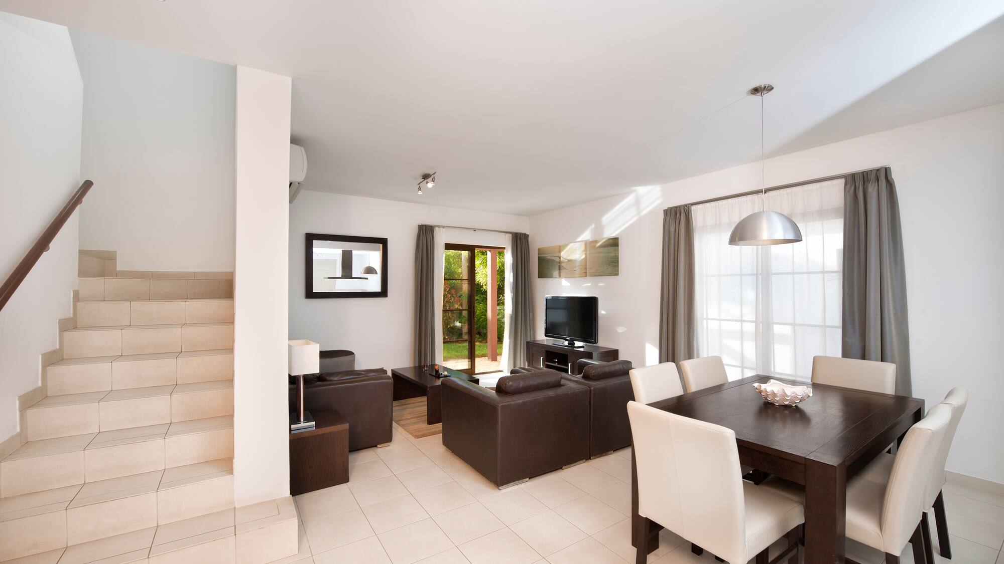 a living room with a table and chairs