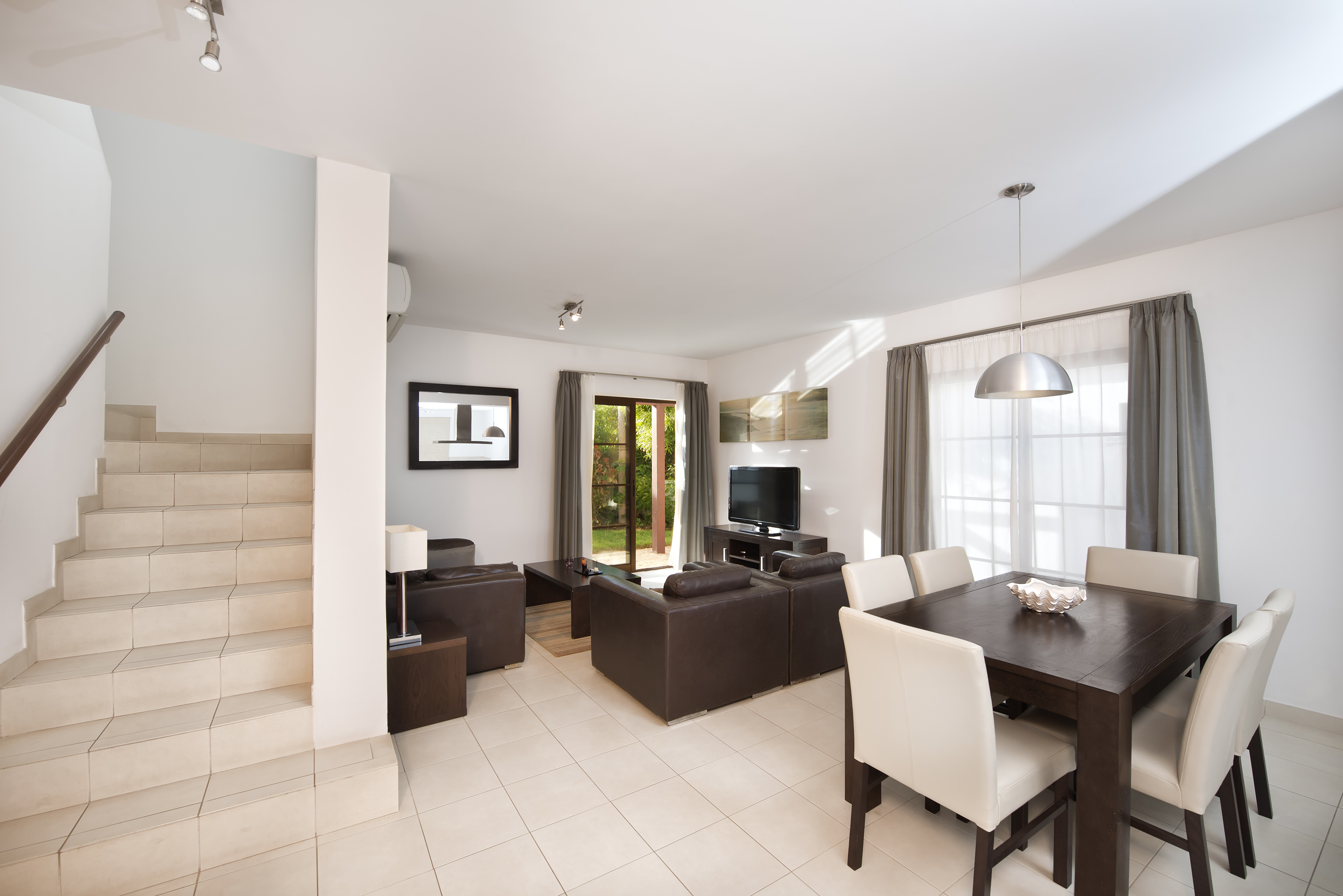 a living room with a table and chairs