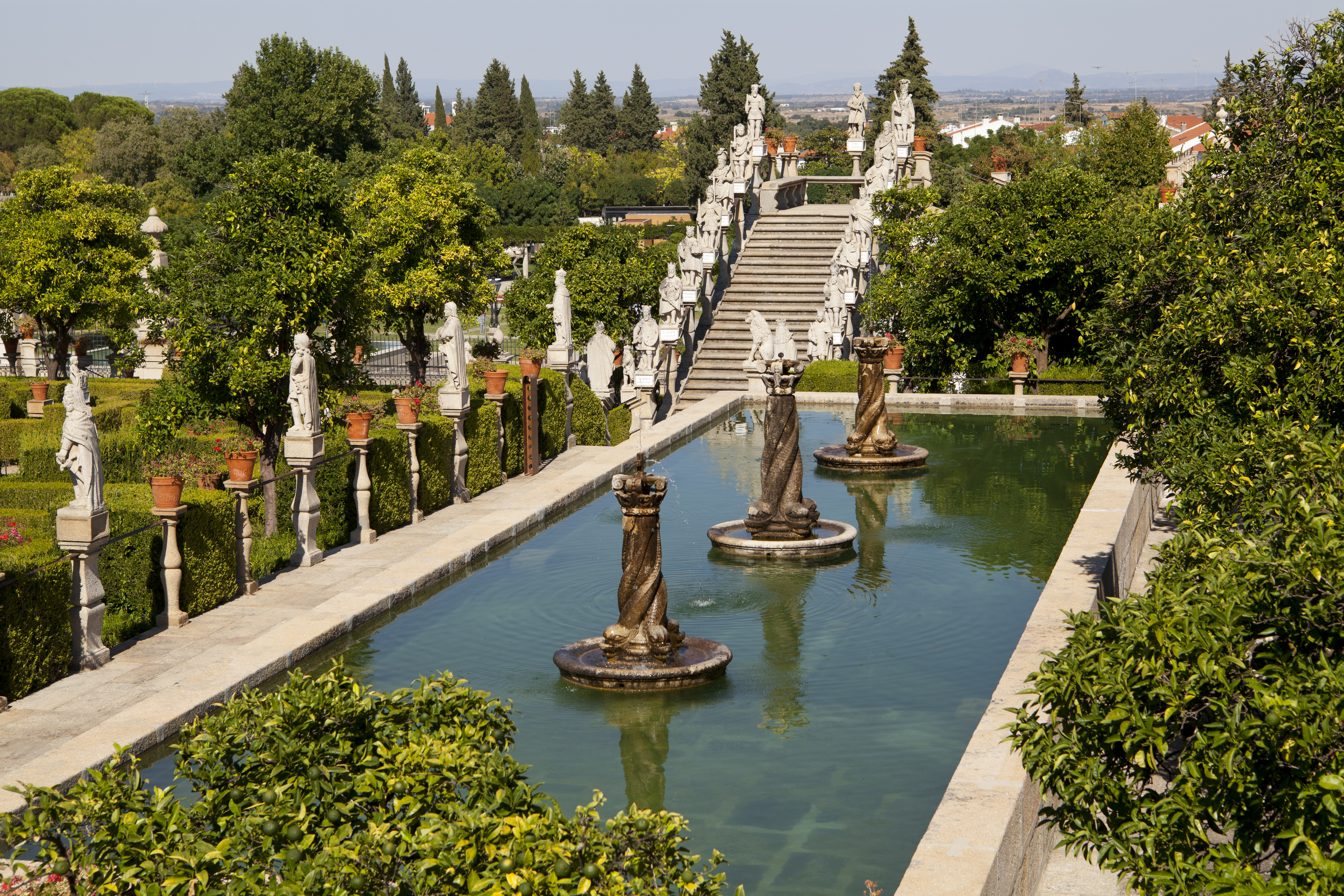 Historic garden, stone staircase, statues, reflecting pool, fountains.