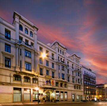 a building with many windows and a street light