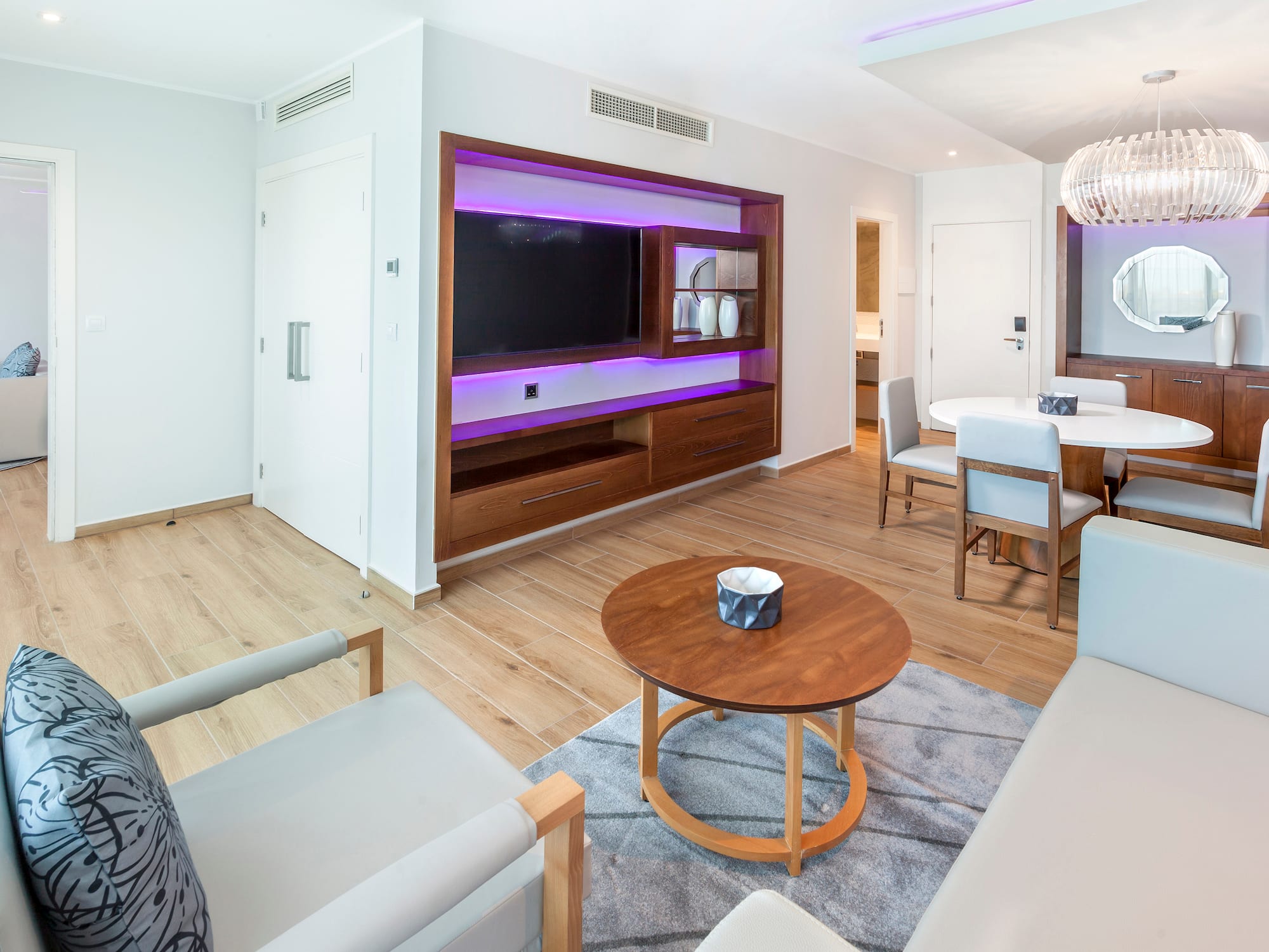 a pool with palm trees and a pool with a deck and chairs