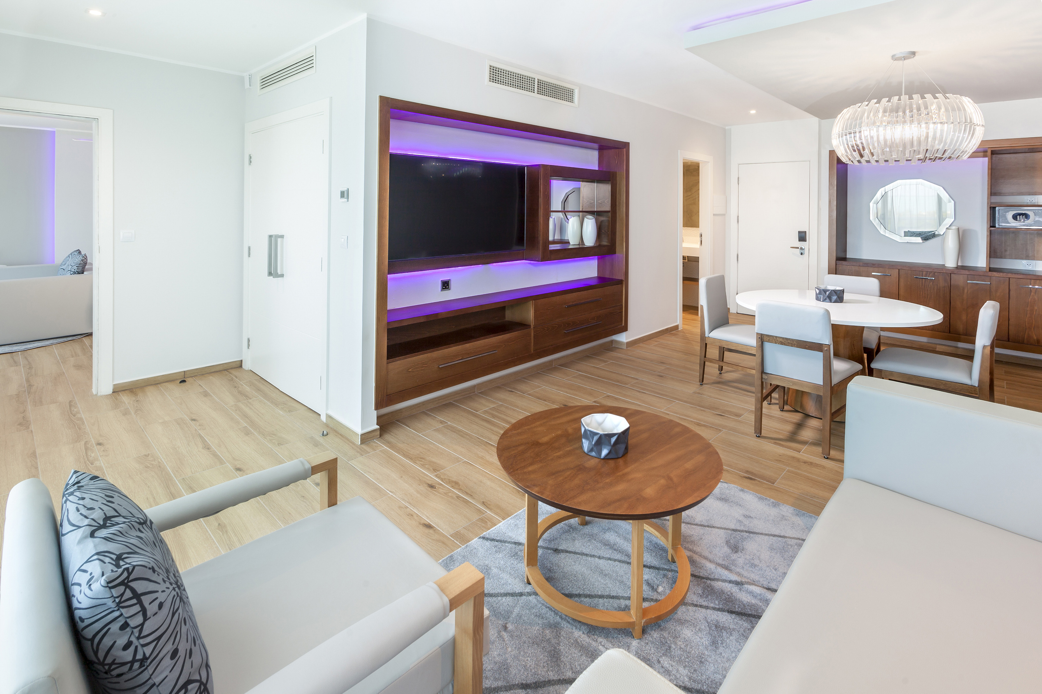 a pool with palm trees and a pool with a deck and chairs