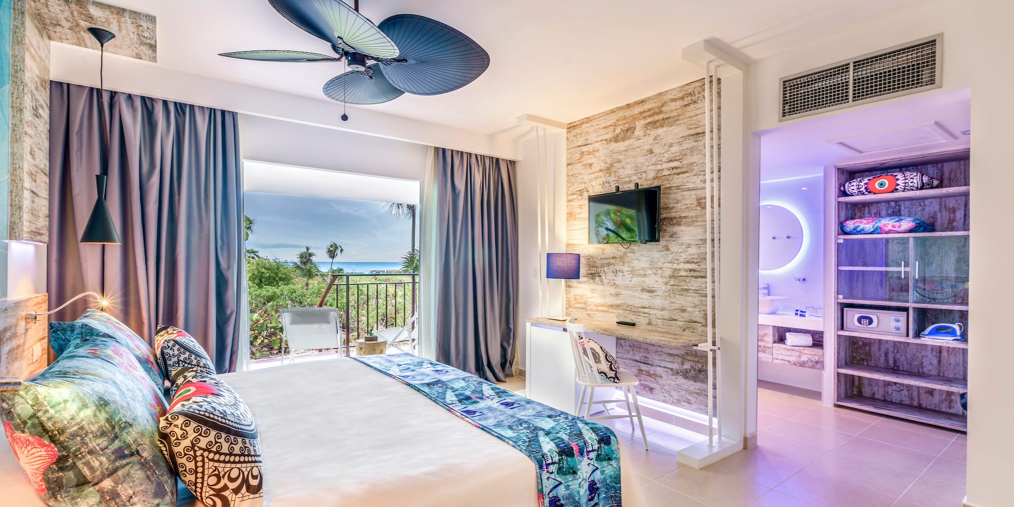 a room with a bed and a ceiling fan