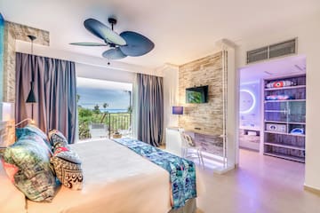 a room with a bed and a ceiling fan