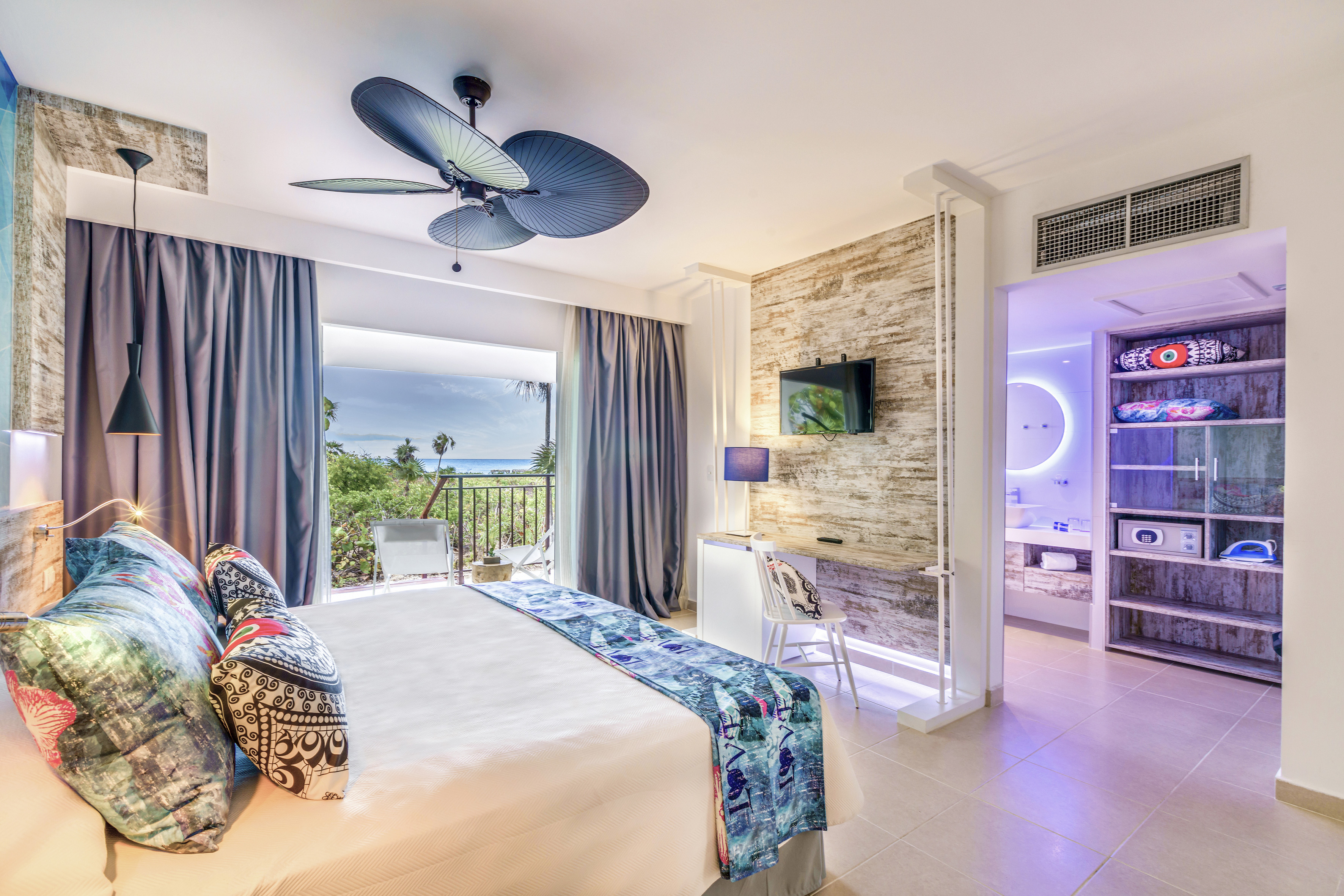 a room with a bed and a ceiling fan