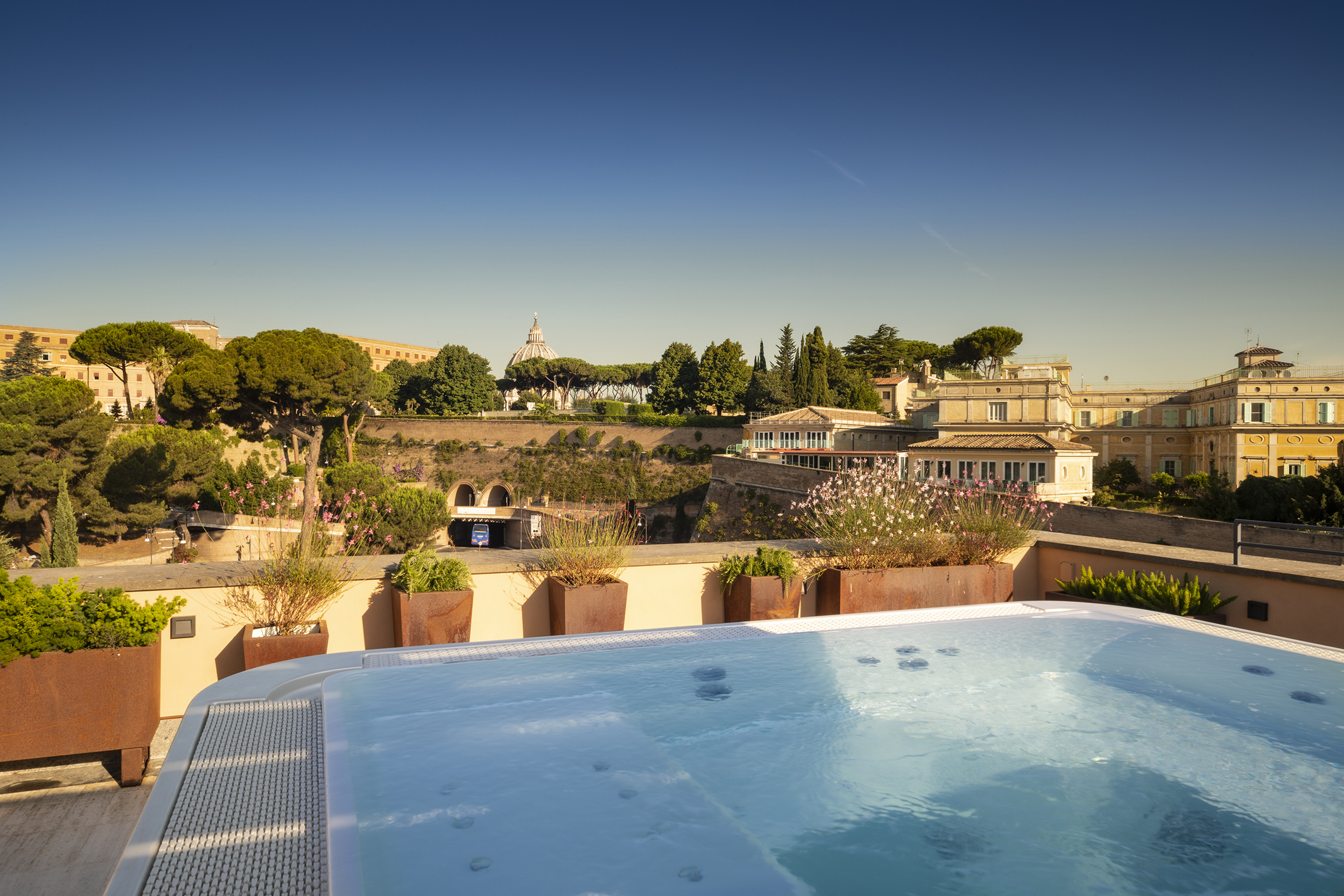 Rooftop jacuzzi with Rome city view and St. Peter's Basilica dome.