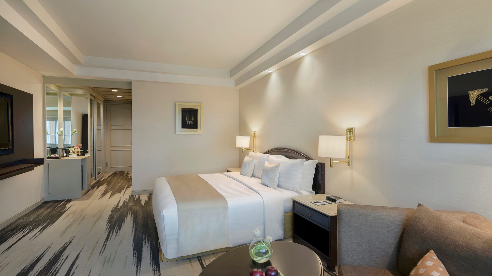 a room with a bed and chairs