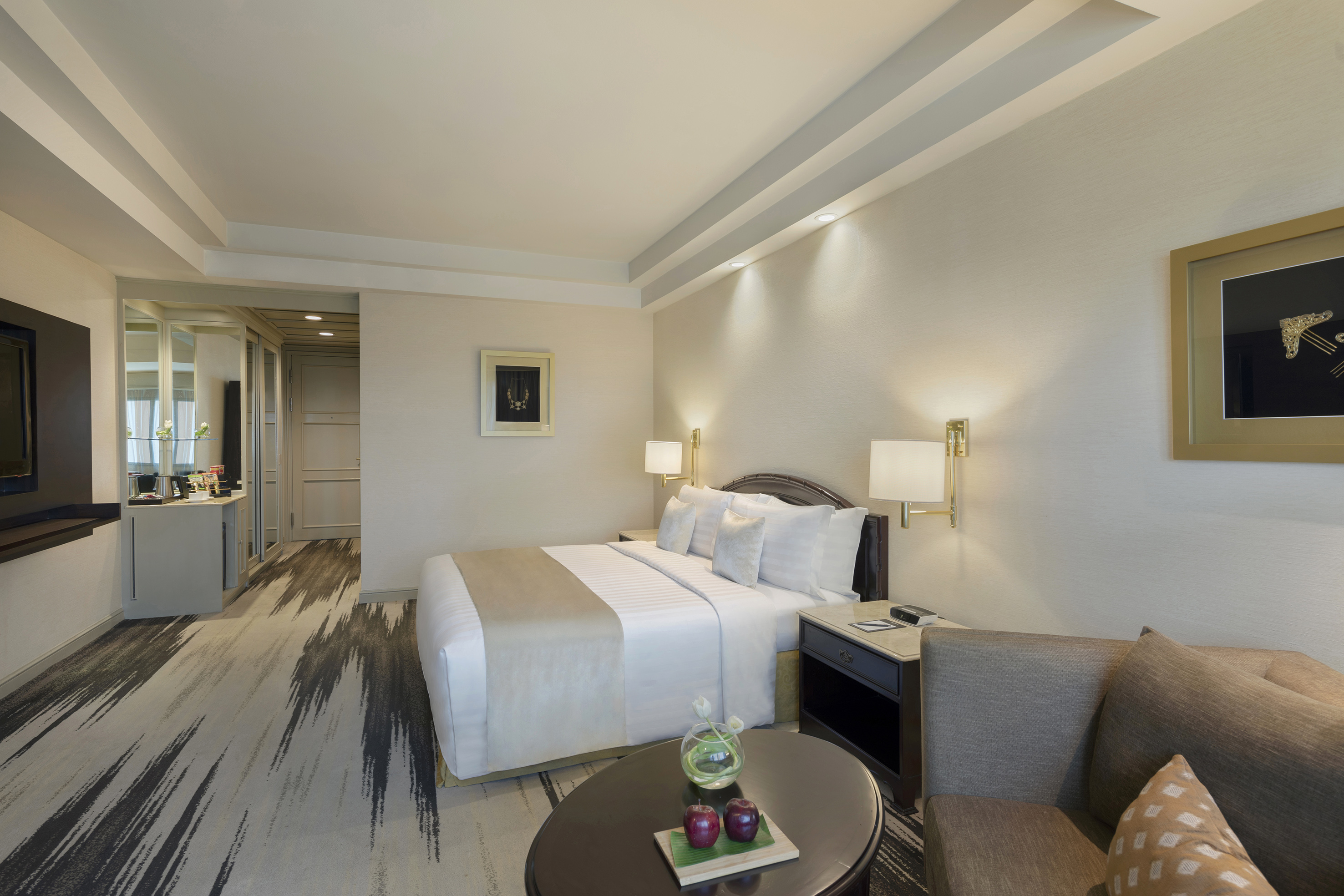 a room with a bed and chairs