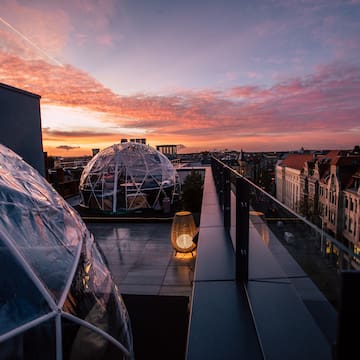 a rooftop with clear dome structures and a city in the background