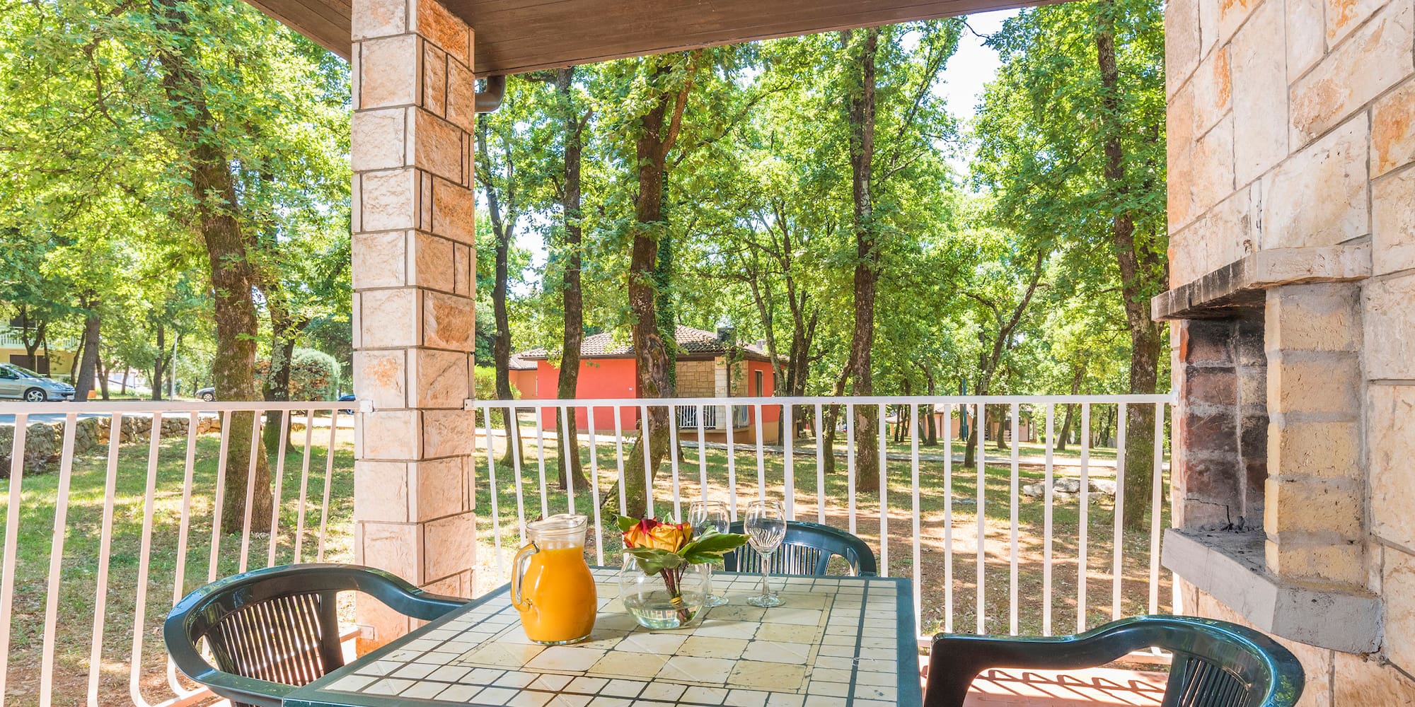 a table with chairs and a pitcher of juice on it