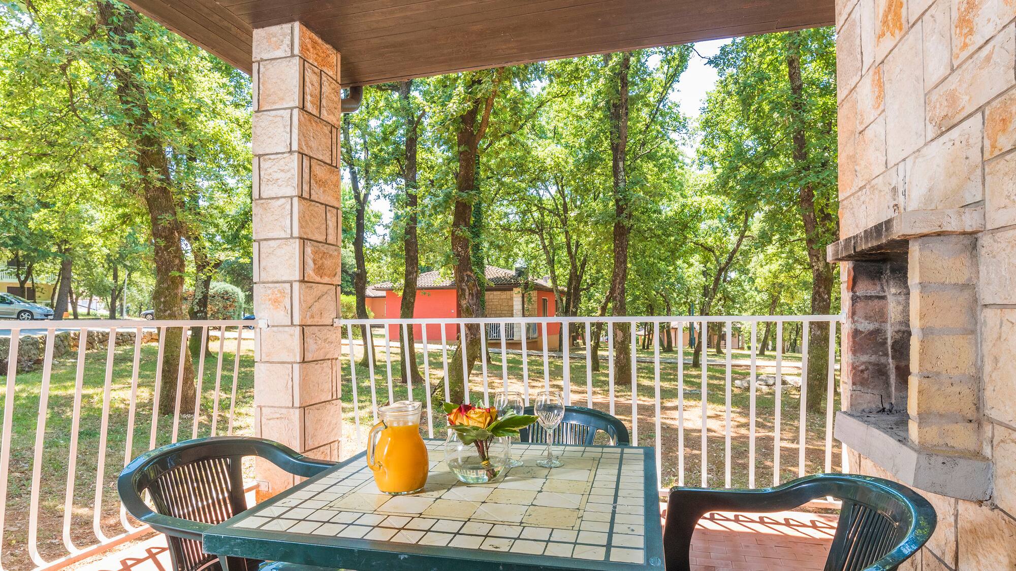 a table with chairs and a pitcher of juice on it
