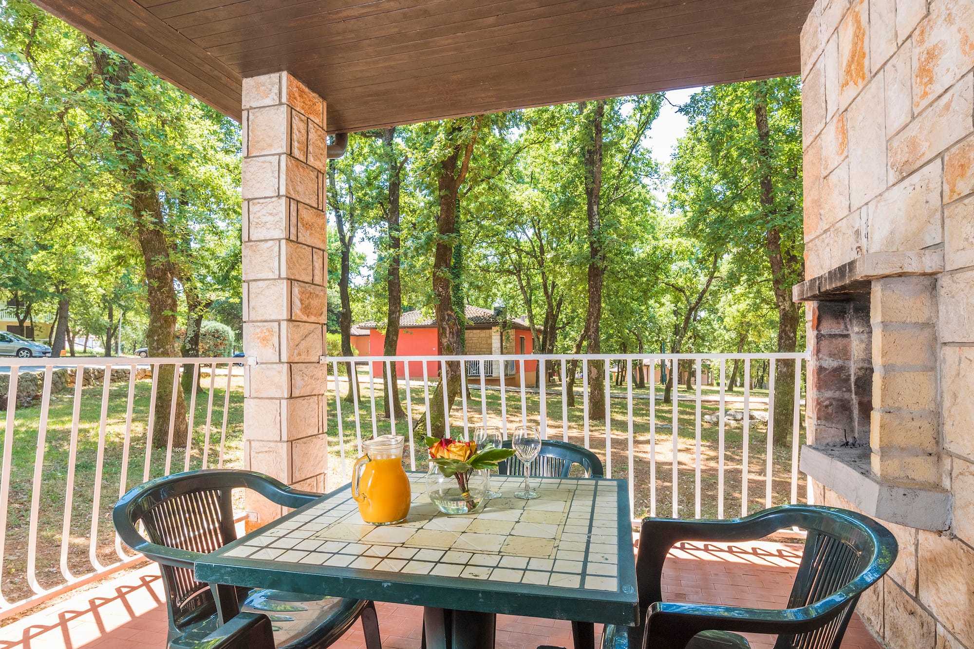 a table with chairs and a pitcher of juice on it