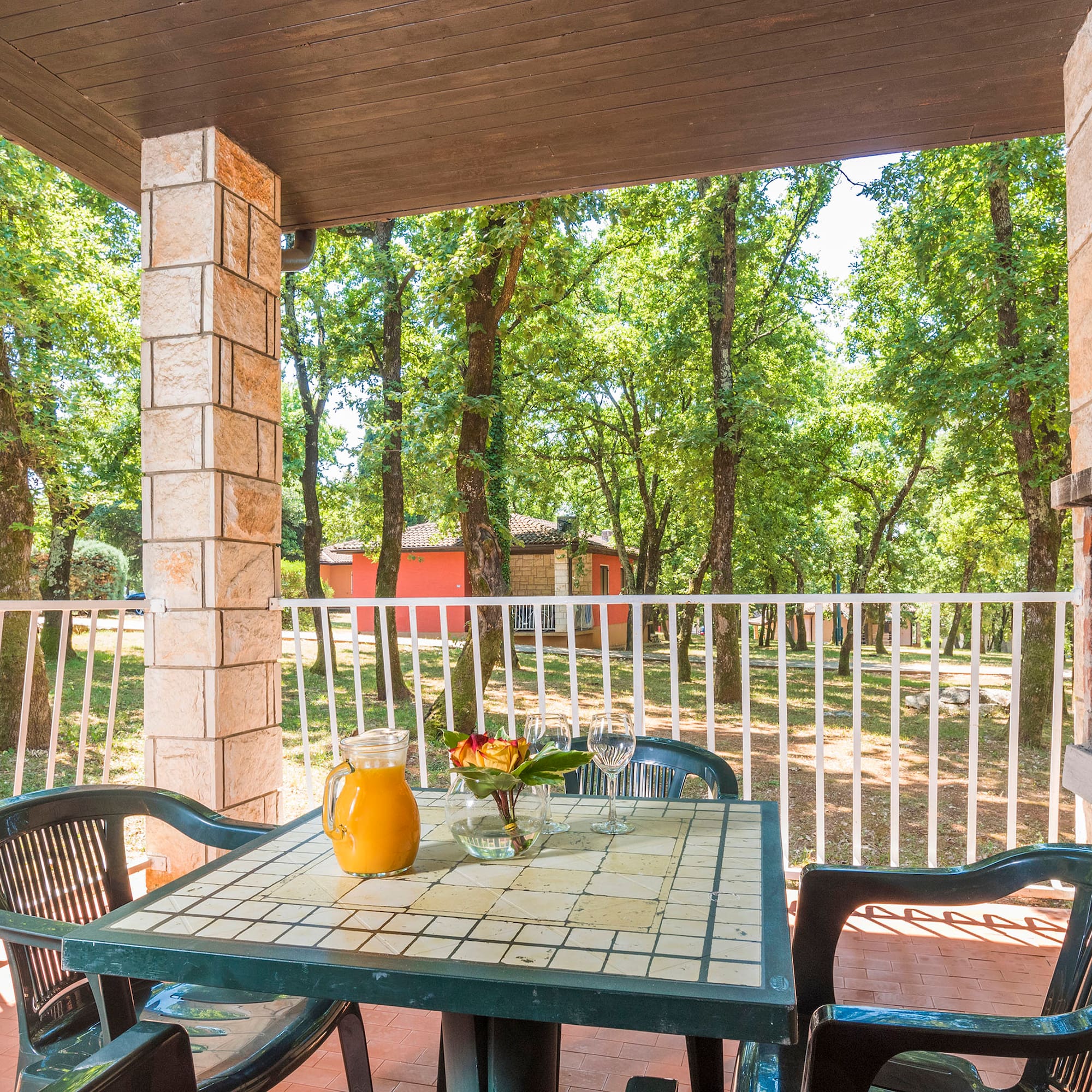 a table with chairs and a pitcher of juice on it