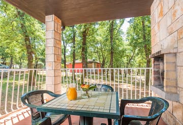 a table with chairs and a pitcher of juice on it
