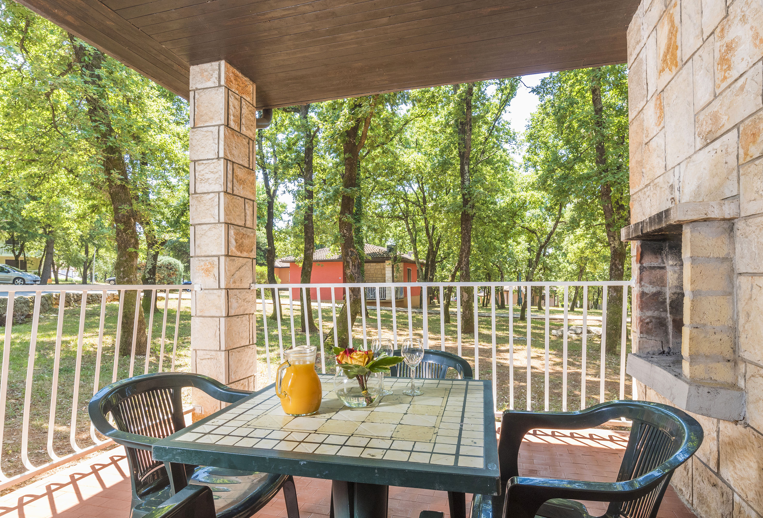 a table with chairs and a pitcher of juice on it