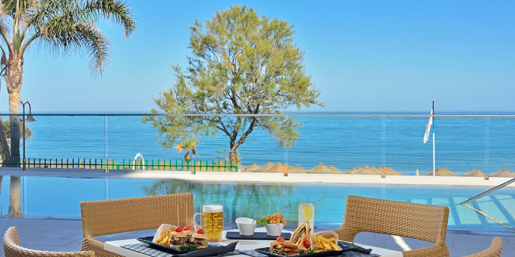 a table with food on it and a pool in the background