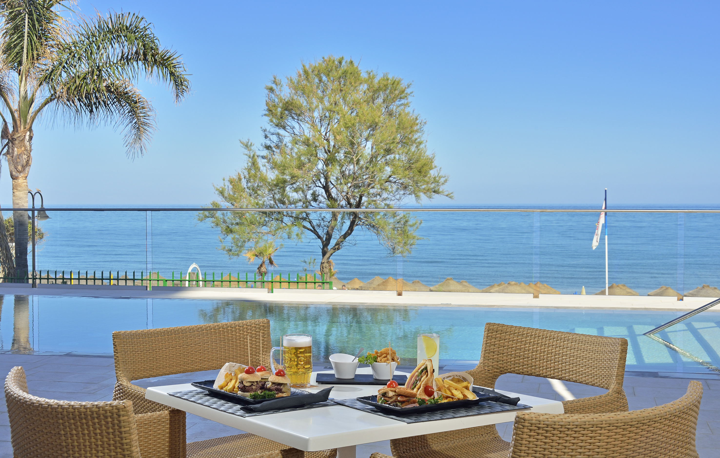 a table with food on it and a pool in the background