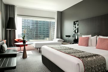a room with a large window and a bed