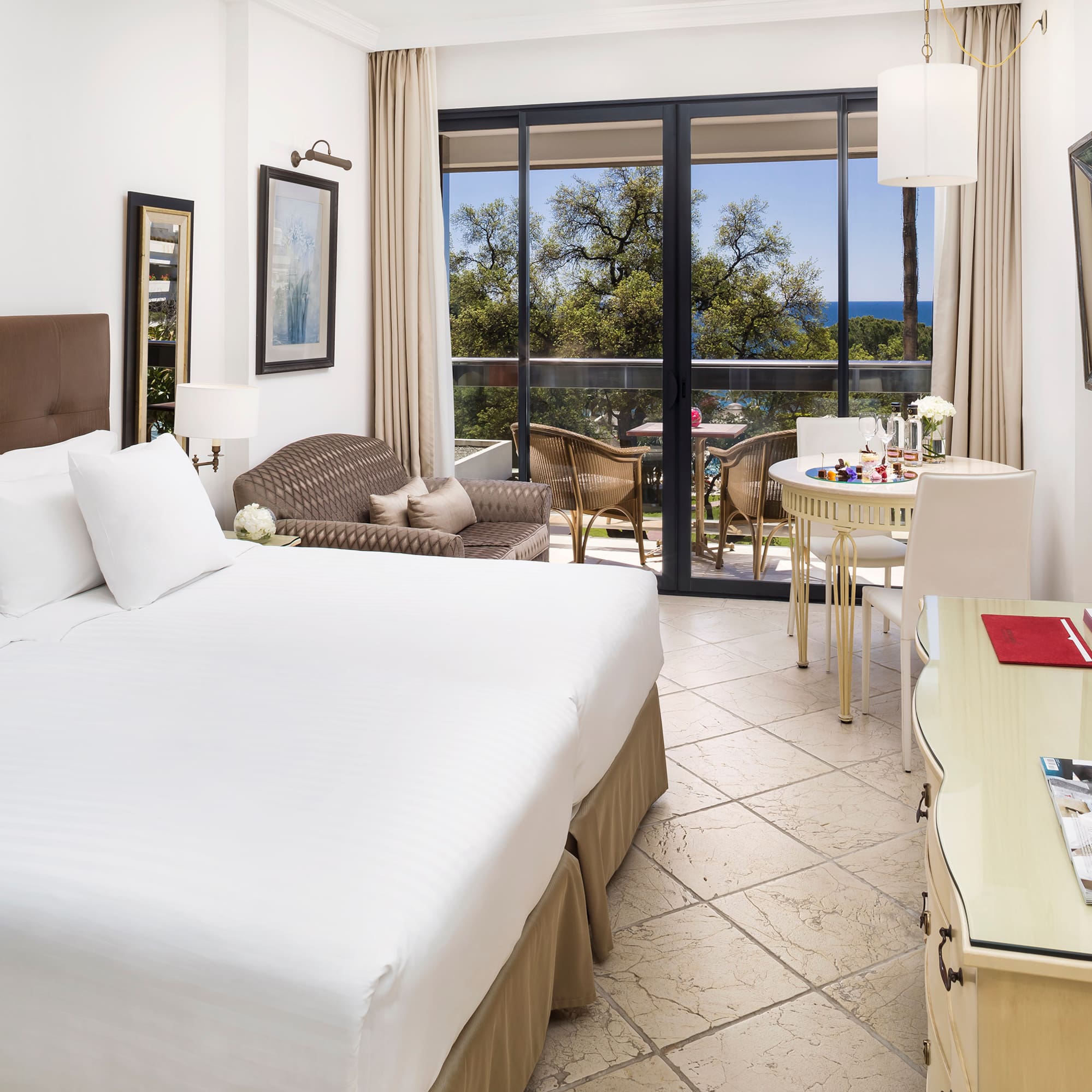 a room with a bed and a table and chairs