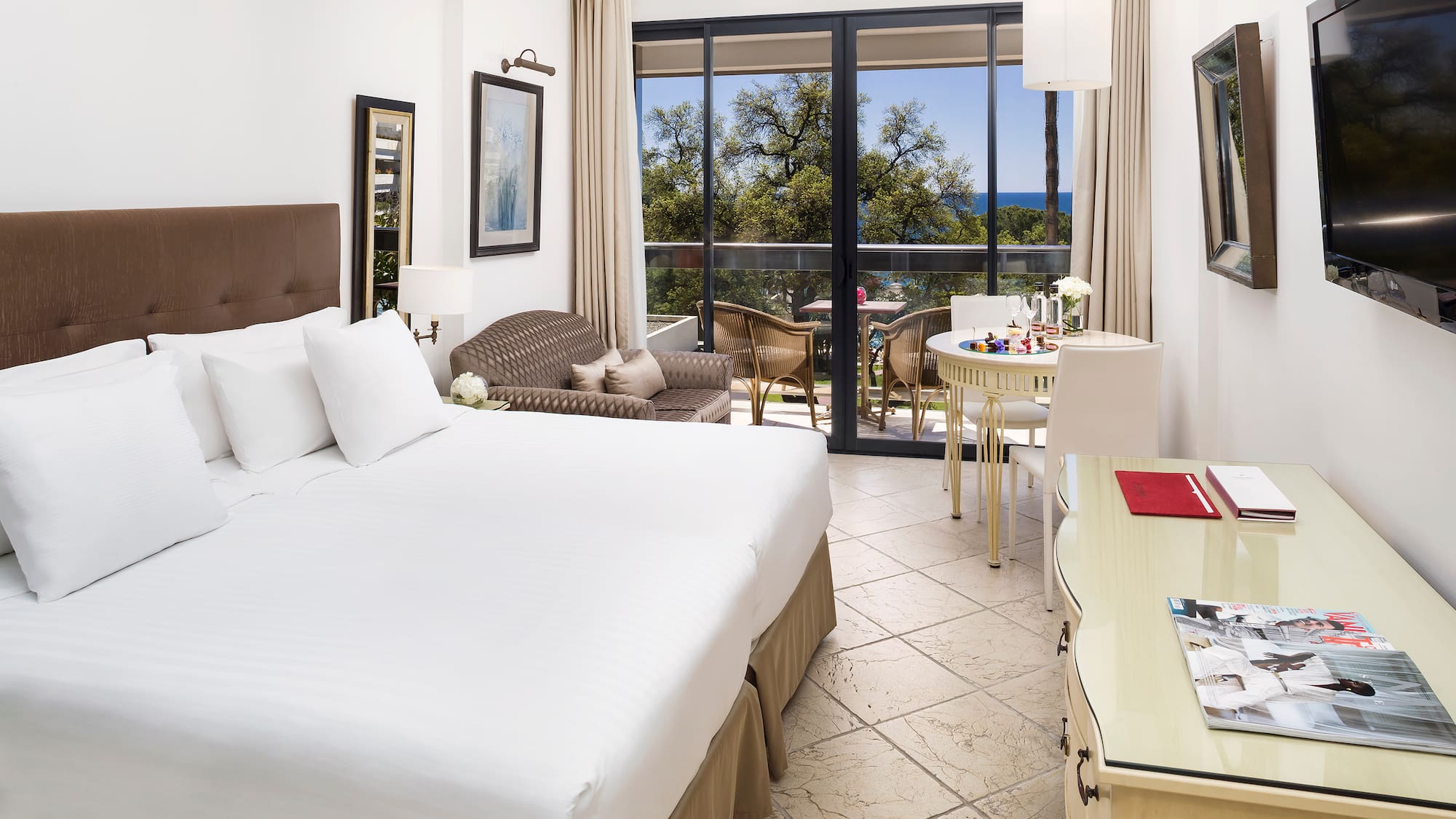 a room with a bed and a table and chairs