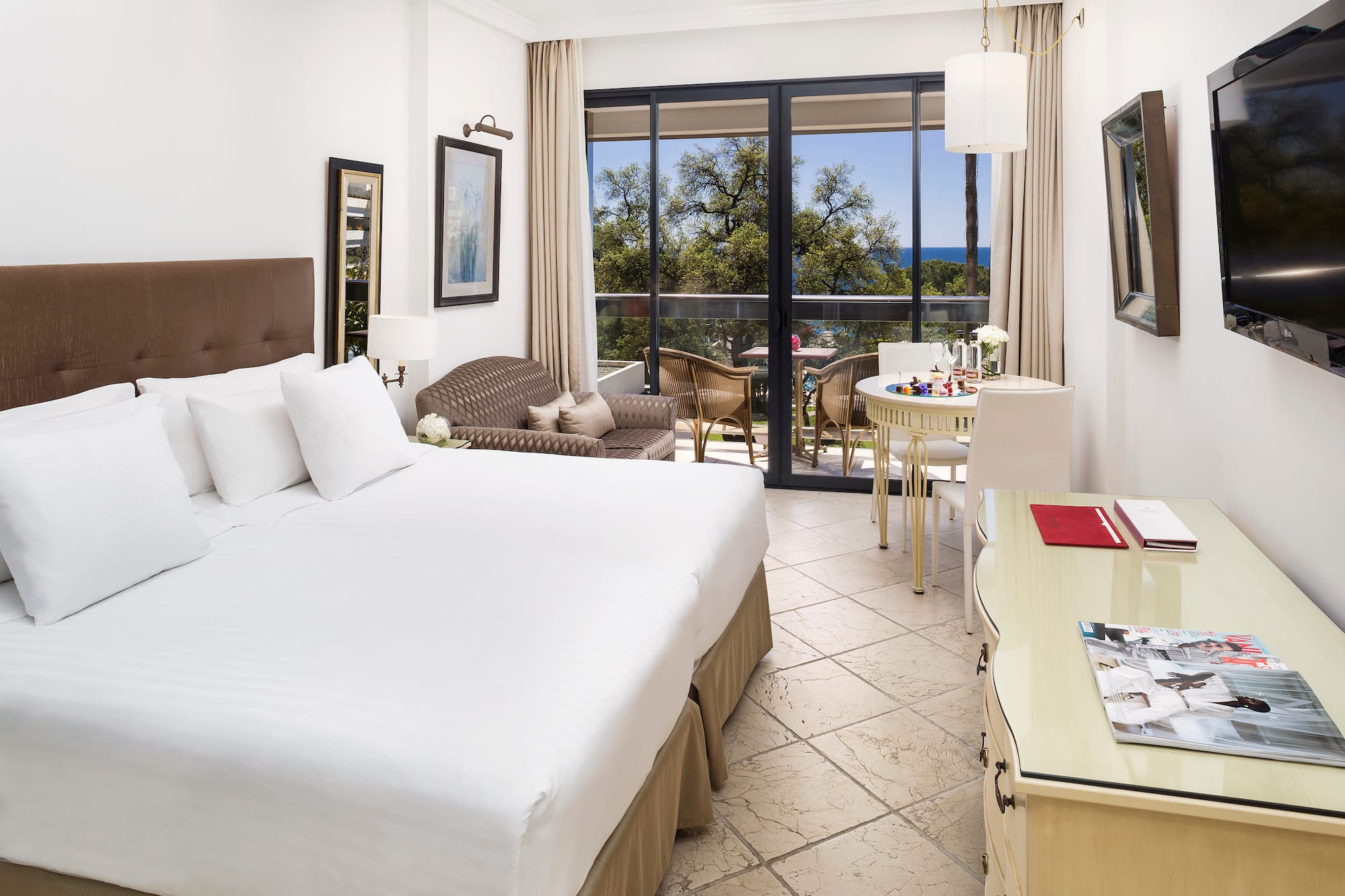 a room with a bed and a table and chairs