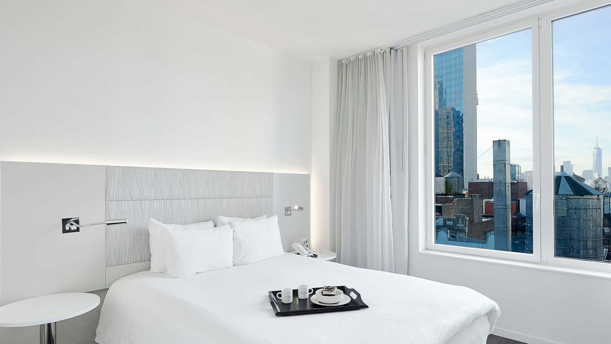 a bed with a tray of tea on it