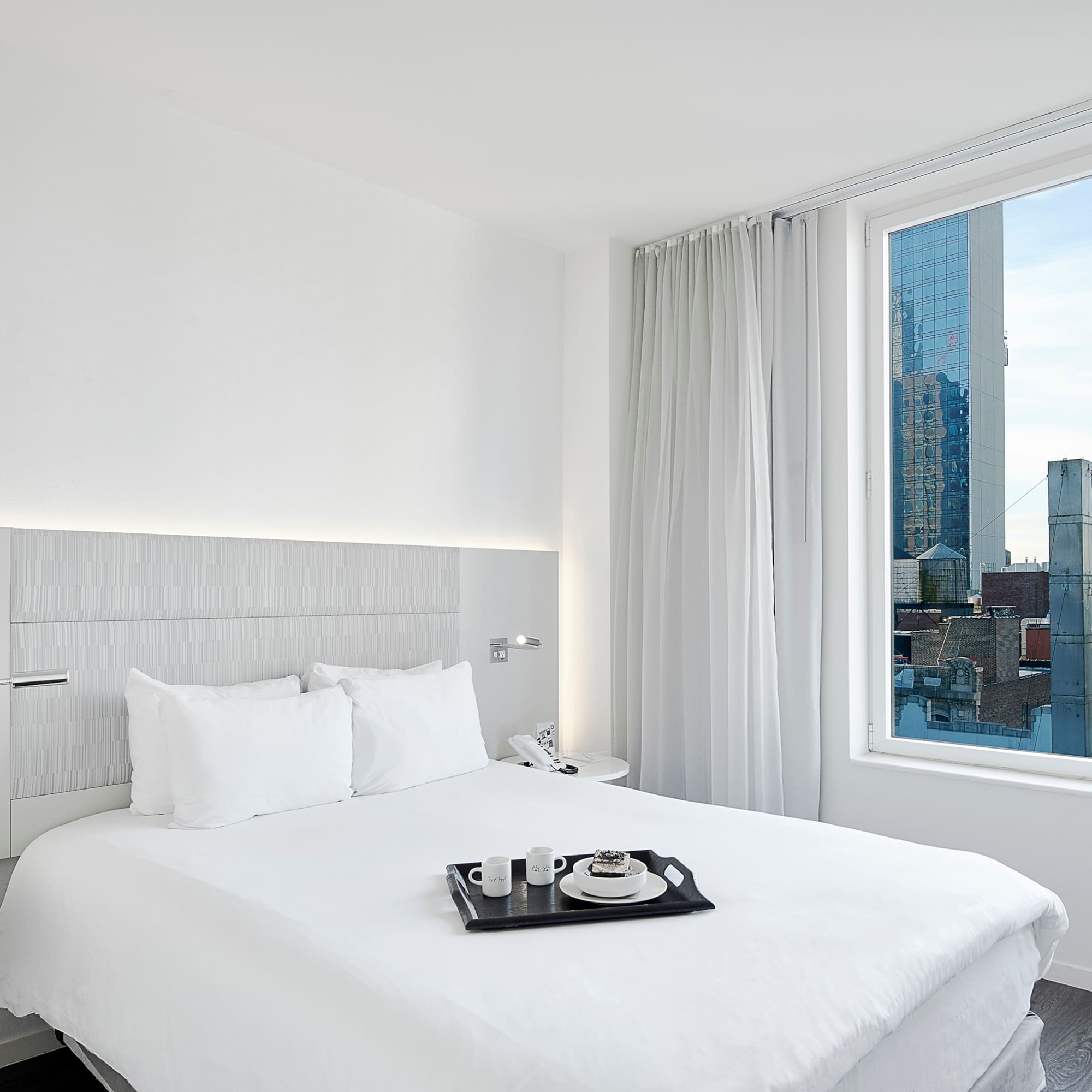 a bed with a tray of tea on it