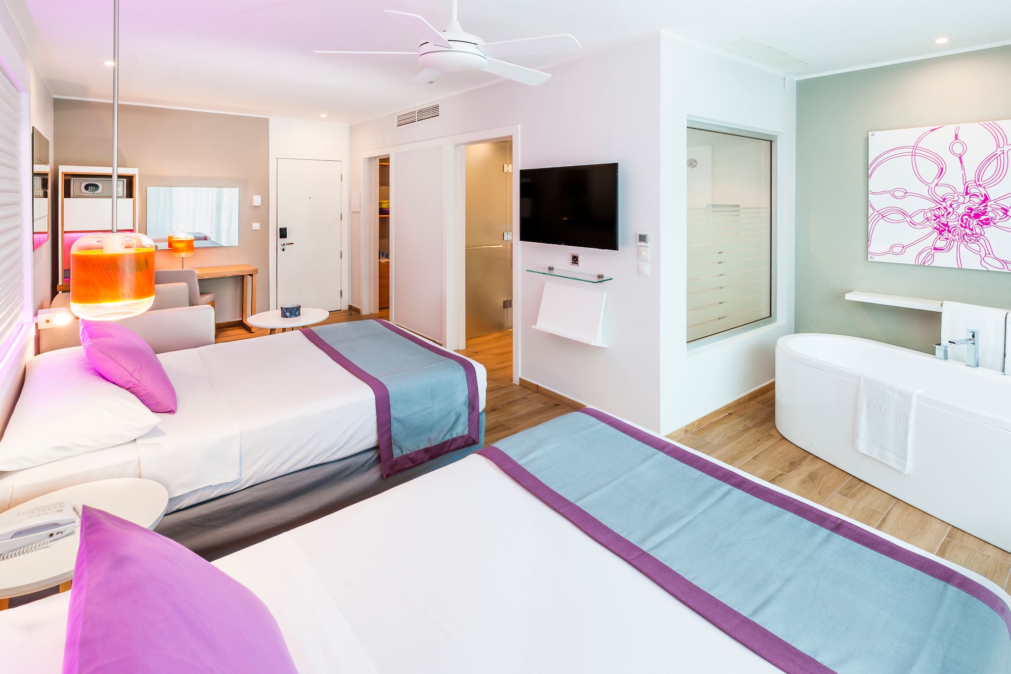 a room with two beds and a tub